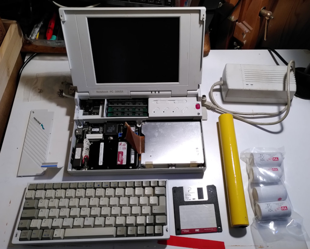 an old i386 laptop being taken apart and refurbished